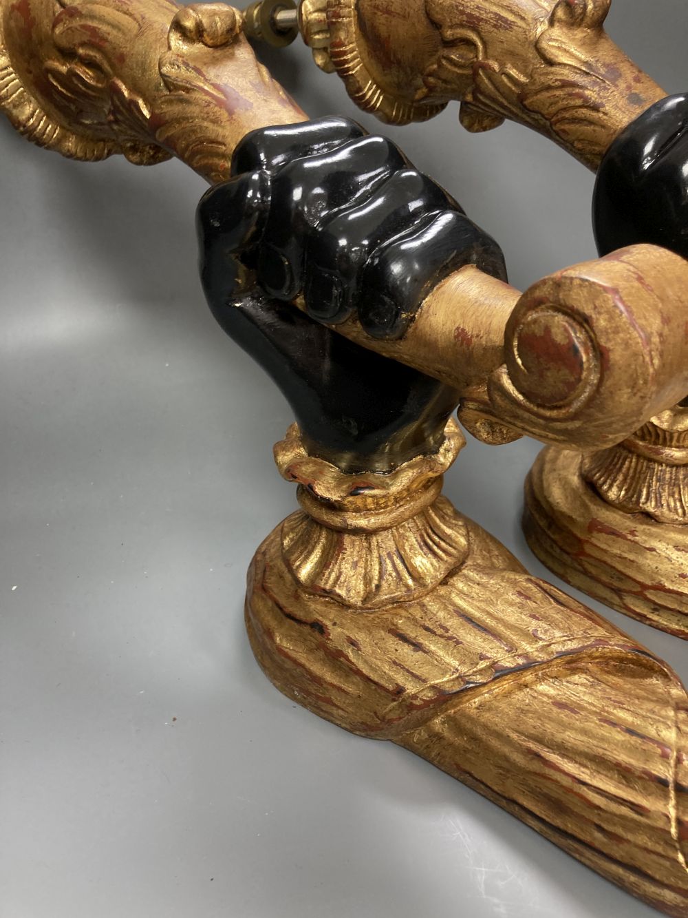 A pair of gilt and ebonised carved wood hand and cornucopia wall sconces, height 52cm not including light fitting